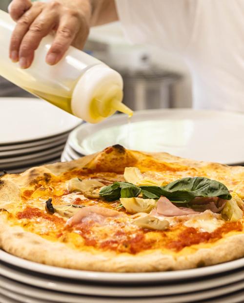 Crisp pizza drizzled with olive oil, ready to enjoy.